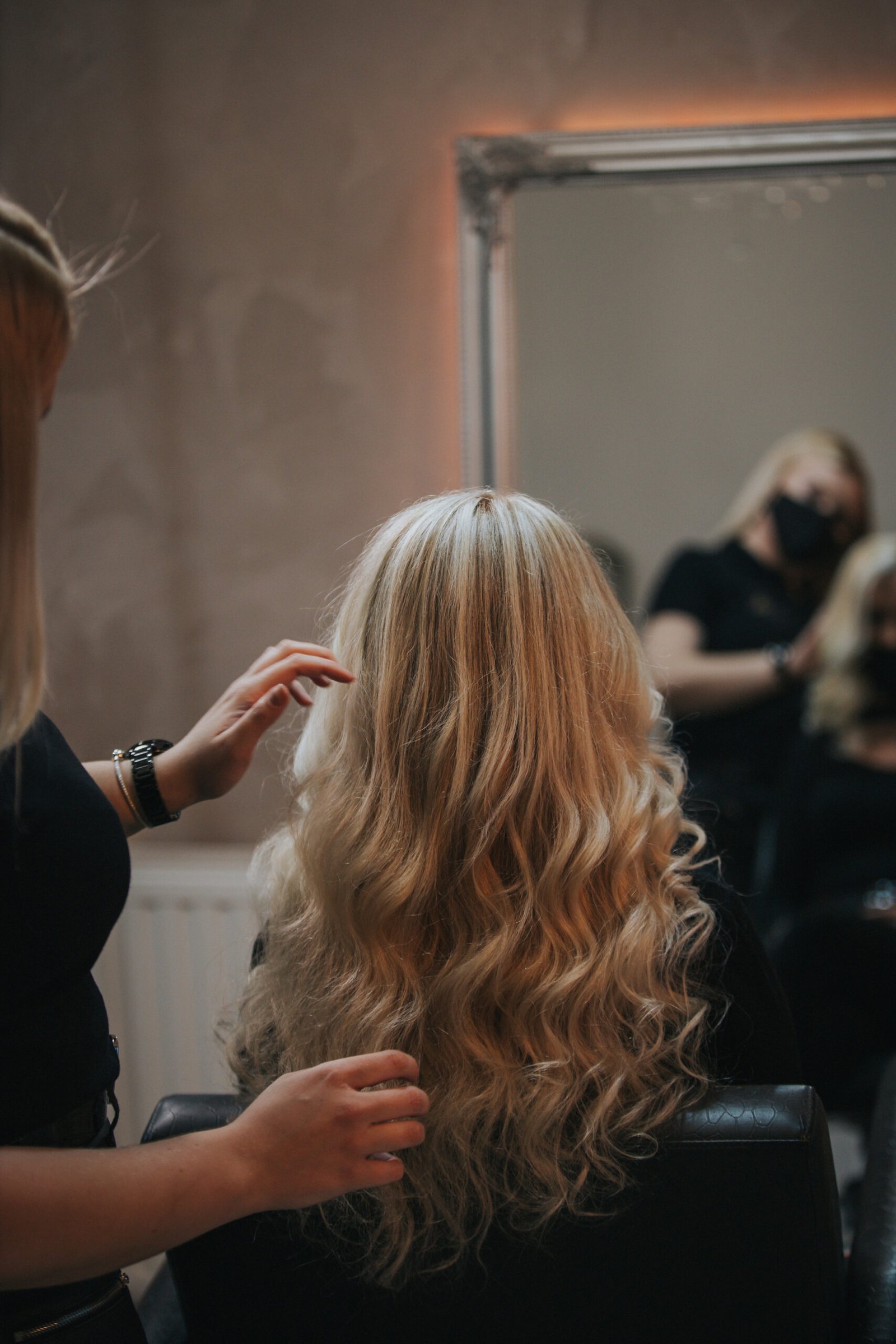 A blonde female getting a new hairstyle at a hair salon
